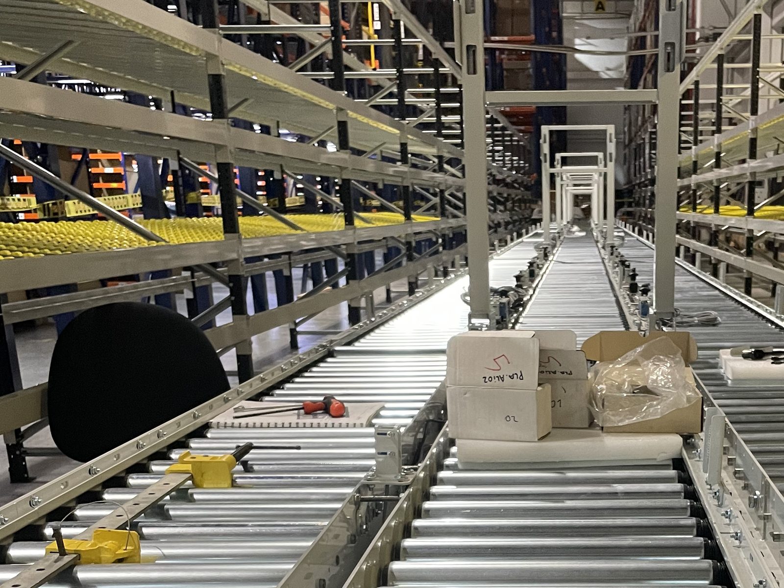 Roller conveyor running between flow-rack picking modules during installation