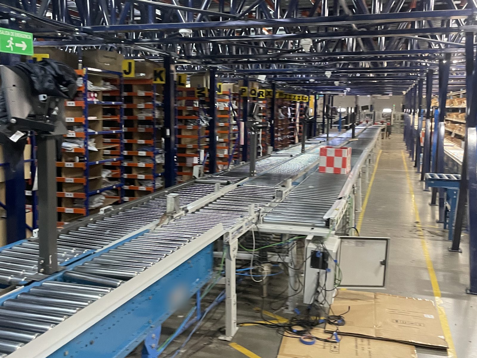 Existing conveyor connected to new conveyor sections inside an operating distribution centre